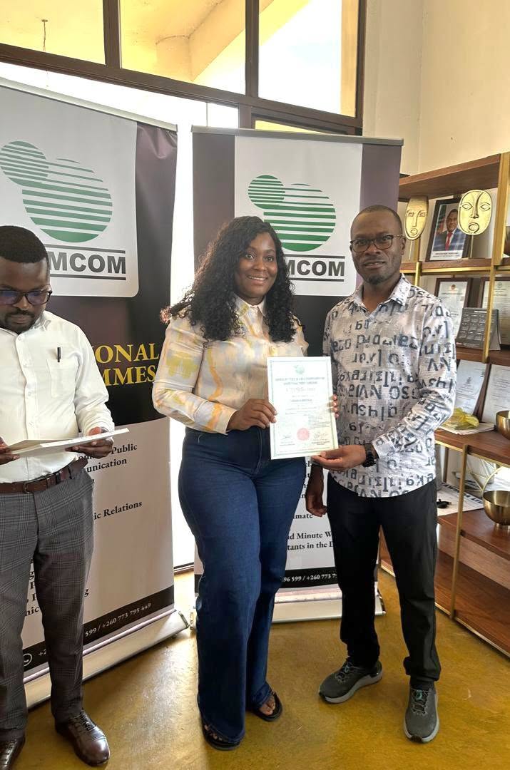 A participant receiving her training certificate